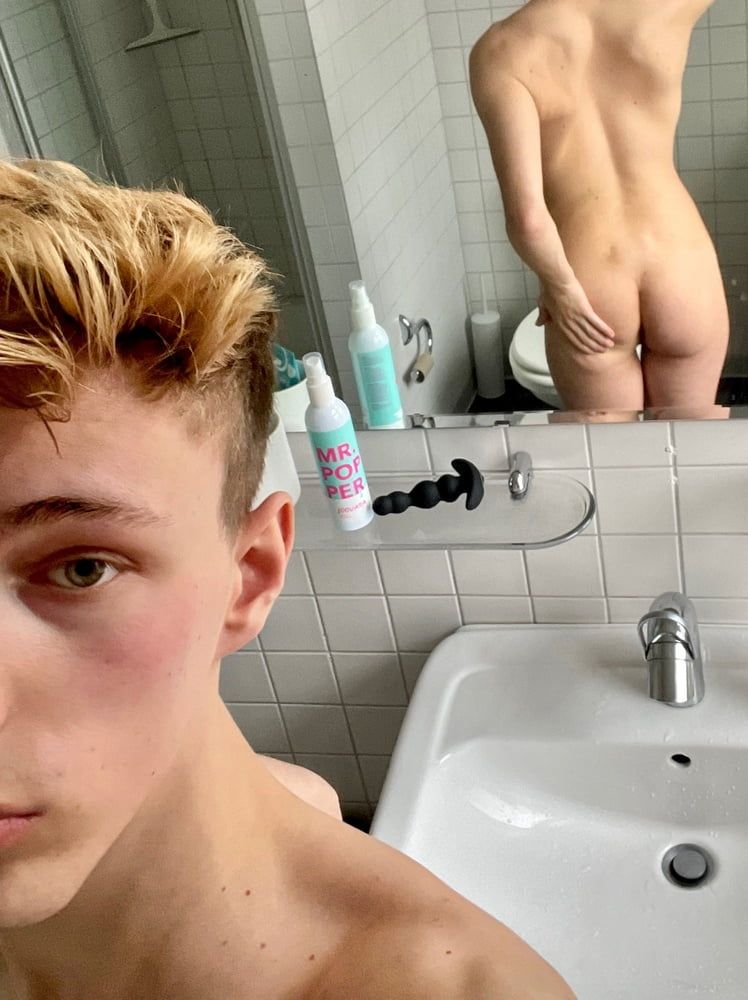 blond boy shows sneaker and ass