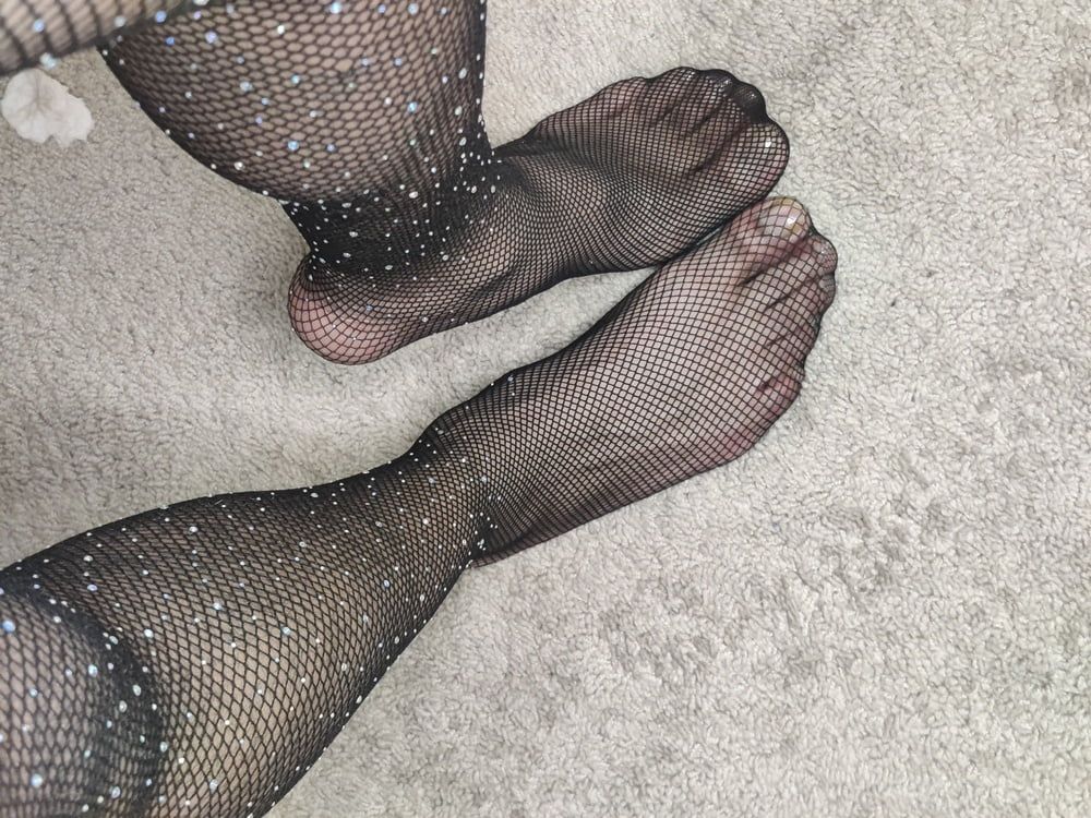 Feet in fishnet pantyhose 