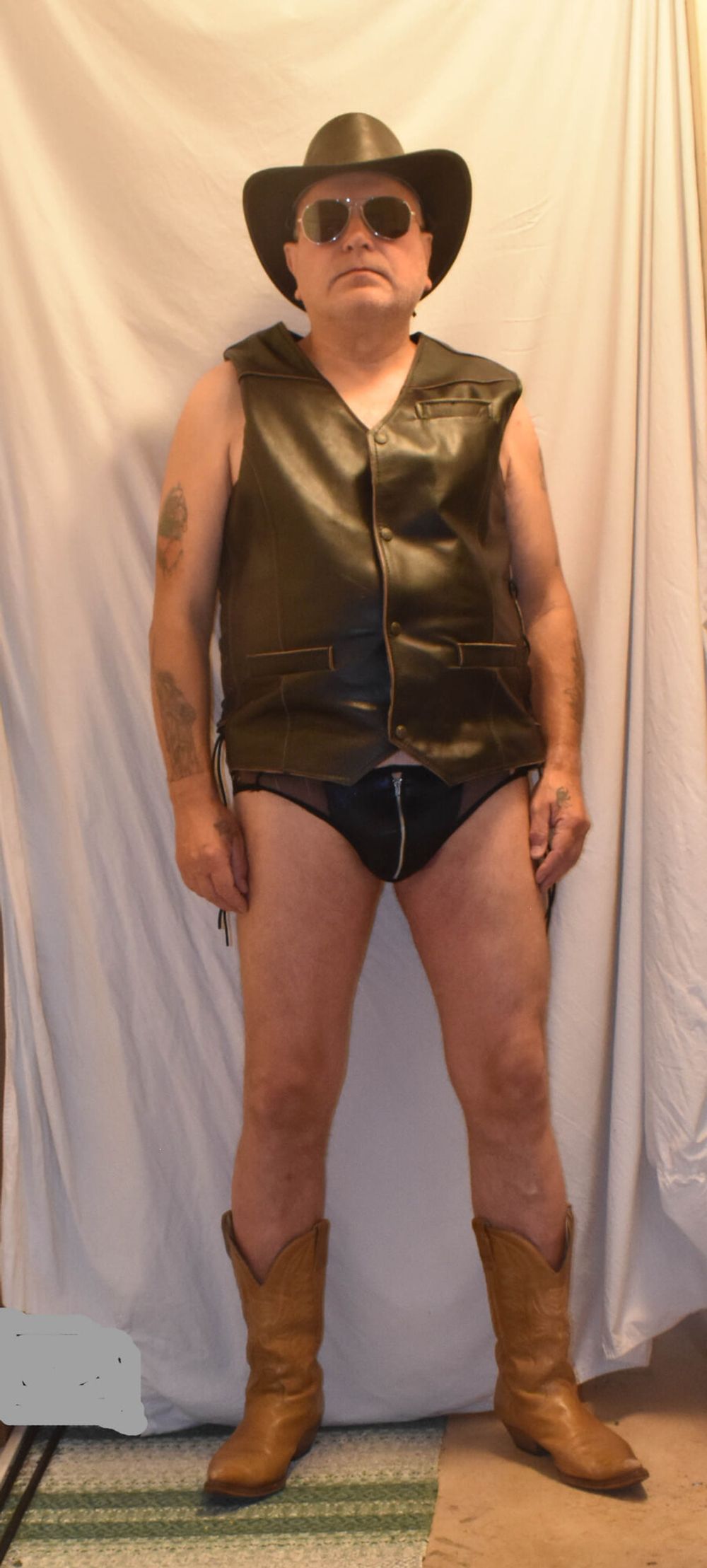 A TIGHT BLACK NYLON WITH A LEATHER AND COWBOY BOOTS. #5