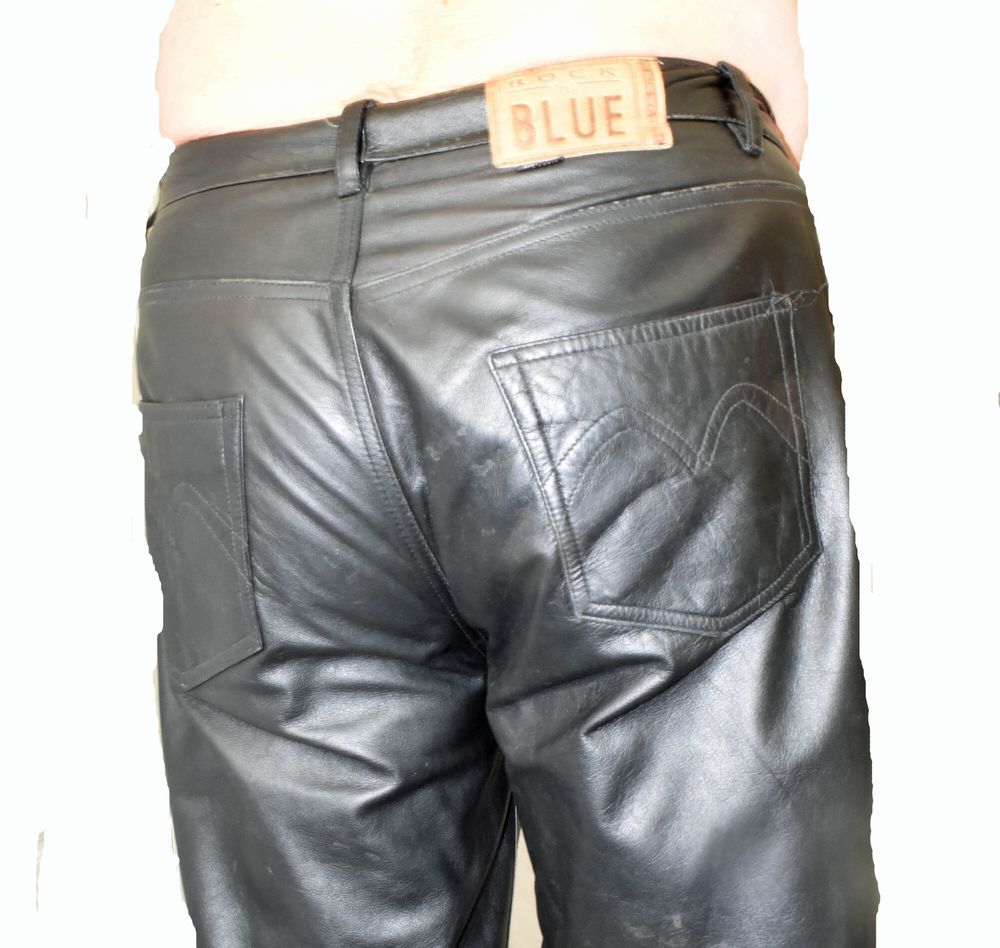 DRESSED IN A TIGHT LEATHER WITH A LEATHER PANTS. #13