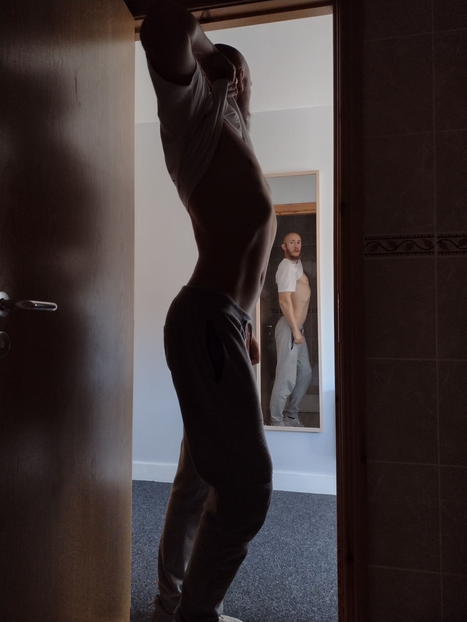 Posing nude in doorway