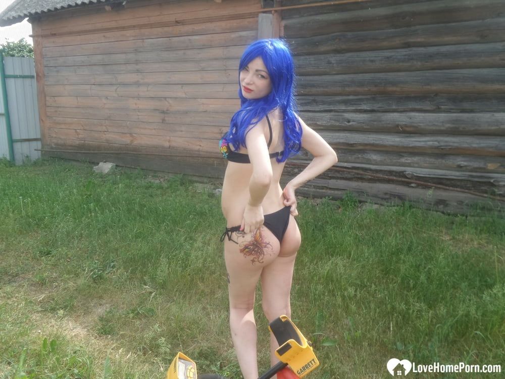 Blue-haired beauty showing her bust while gardening #8