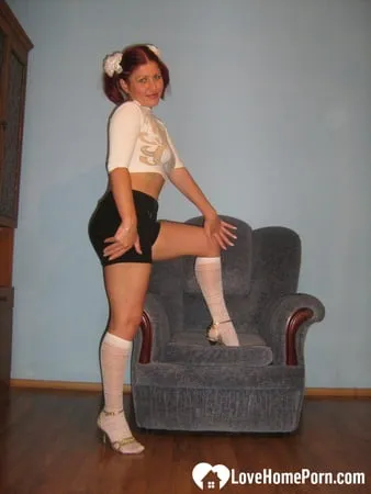 flexible teen in knee socks uses a toy         