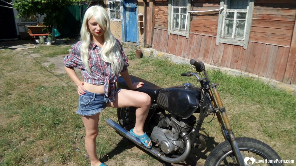 Blonde babe posing naked on a bike #6