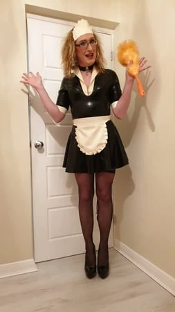 latex maid with a pump up anal plug stockings and heels         