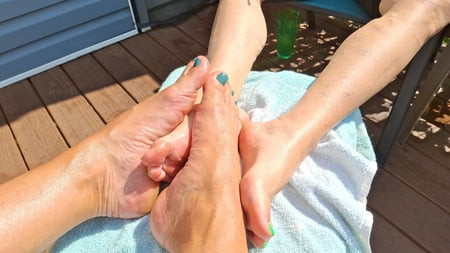 Showing off our matching toes and oiled feet in the sun