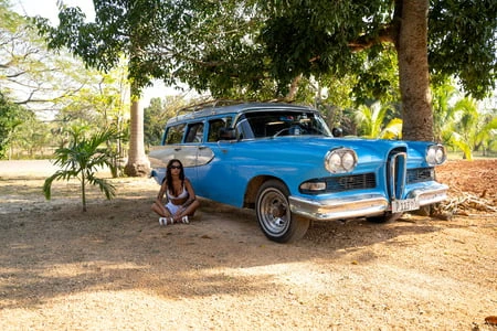 monika fox in white next to a vintage car in cuba         