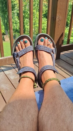 My handsome male feet with painted toes in sandals 