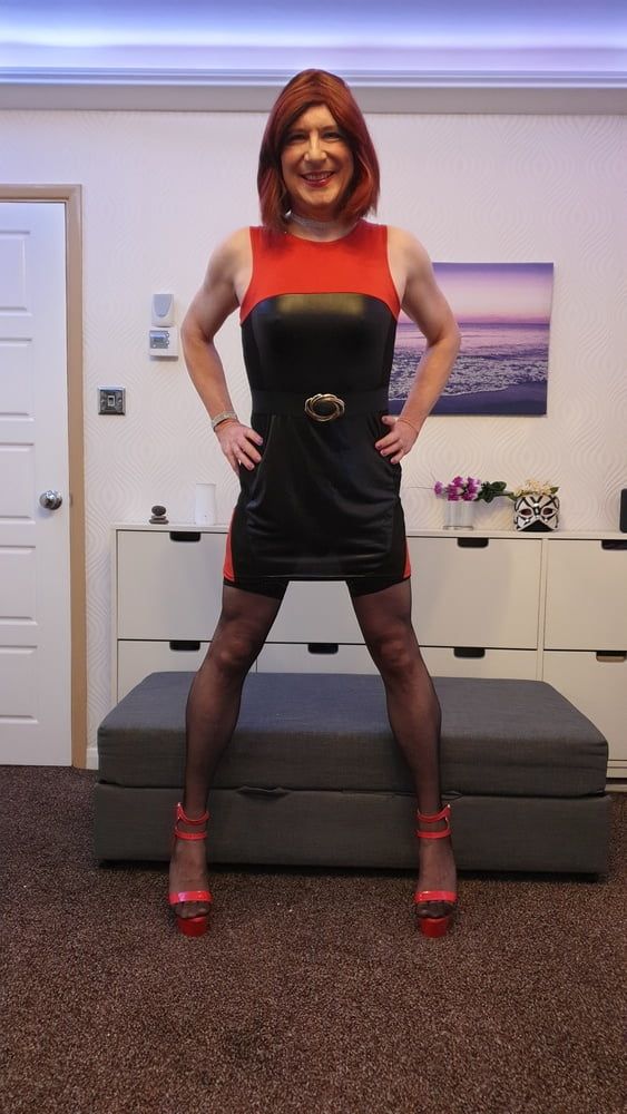 TGirl Lucy posing and playing in black and red bodycon dress