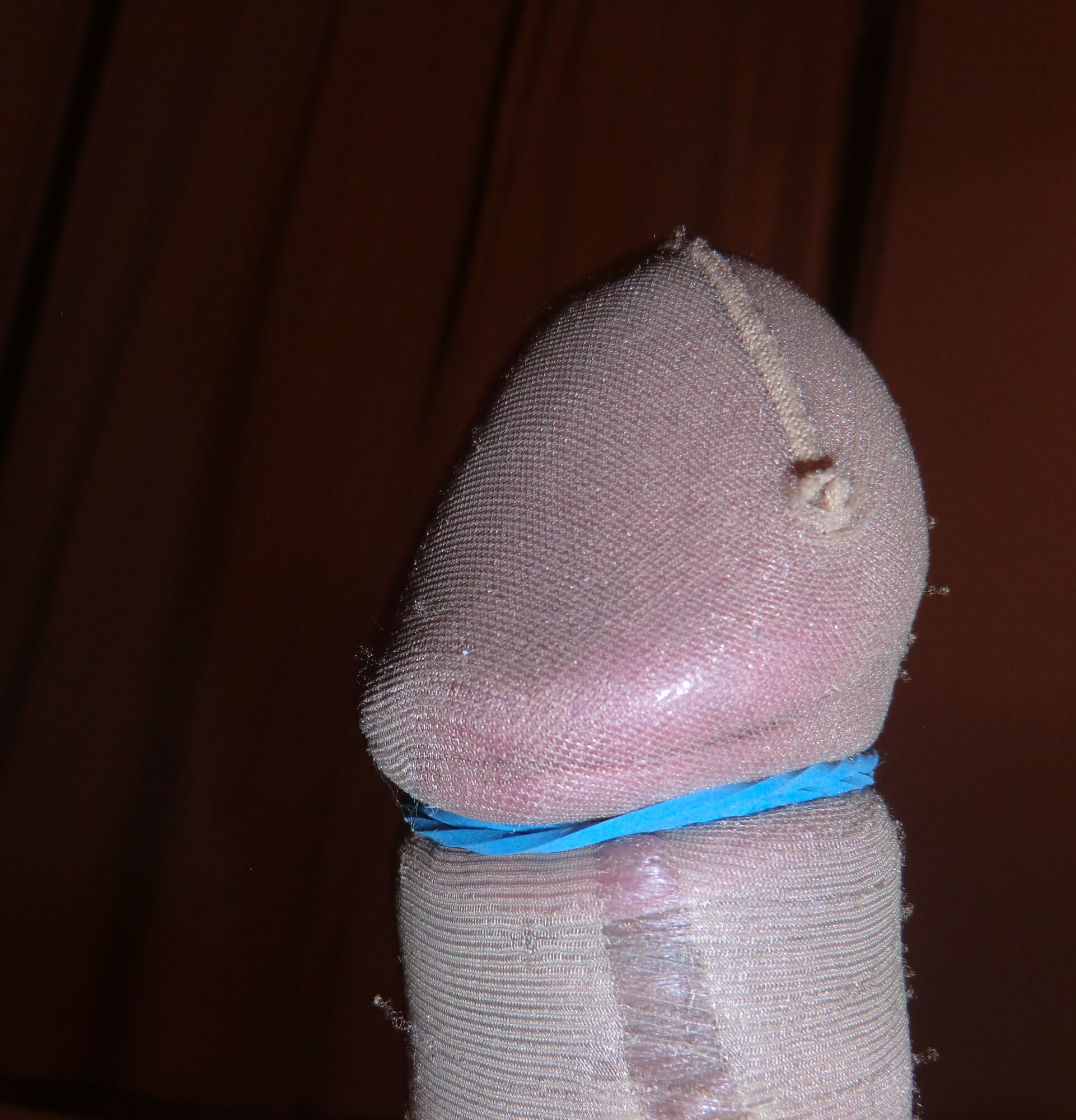 Bulky, shiny nylon glans straining against the fabric