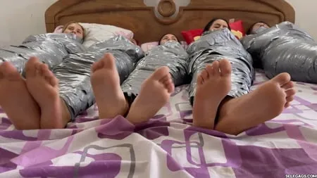   mummified girls barefoot in duct tape bondage         