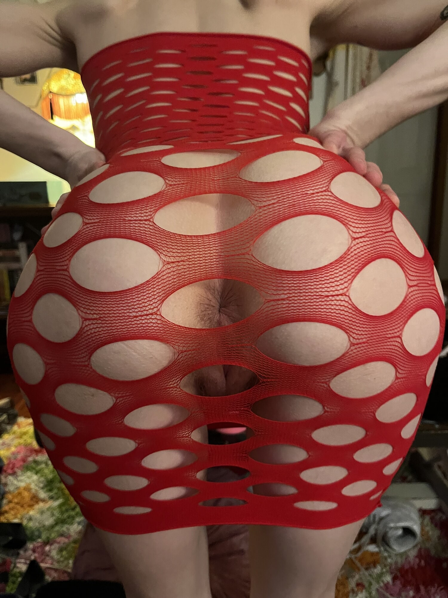 Hot slut in red fishnet dress exposes asshole