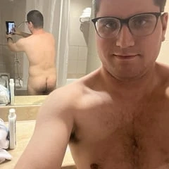 Naked in front of a mirror in the bathroom