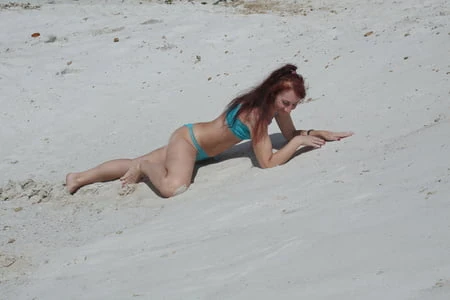 on white sand in turquos bikini         