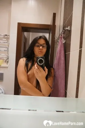 cute nerdy babe taking some hot selfies         