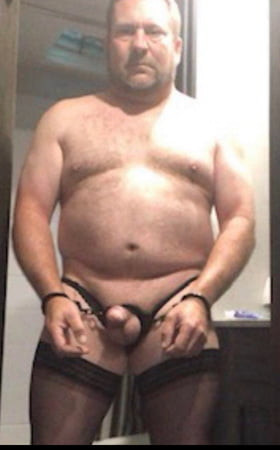 Brandon Hegsted wearing thigh highs., panties and cuffs