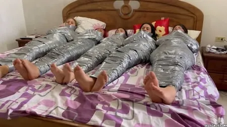   mummified girls barefoot in duct tape bondage         