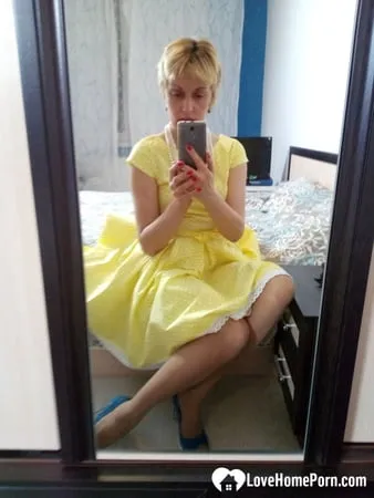 stunning milf puts on a yellow dress         