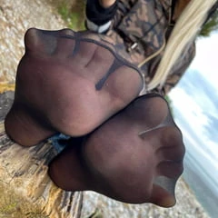 In dirty black nylon socks on the seashore