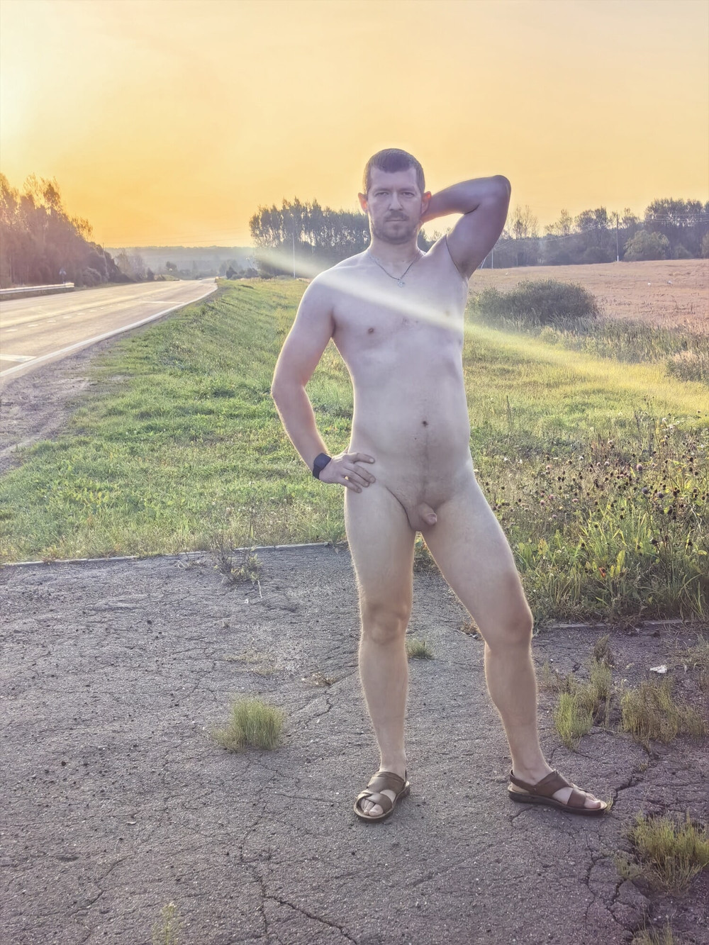 A Russian guy is photographed completely naked near a highwa #10