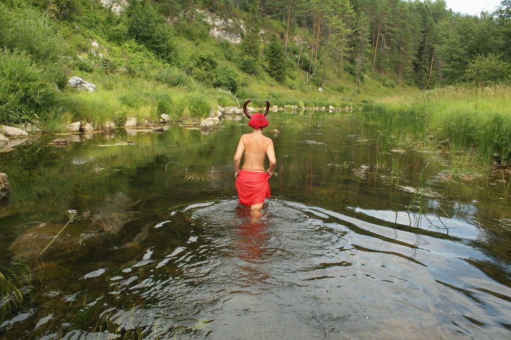 With Horns In Red Dress In Shallow River