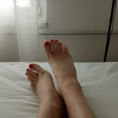 bare smooth slender legs with red painted toes