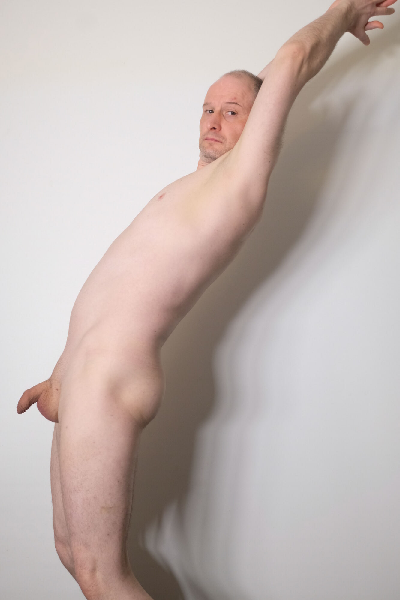 Jonathan Strips naked and poses showing his soft penis