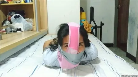 panty hooded girl gagged with socks and tape         