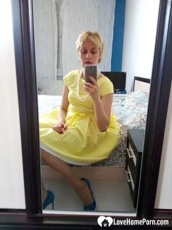 stunning milf puts on a yellow dress         