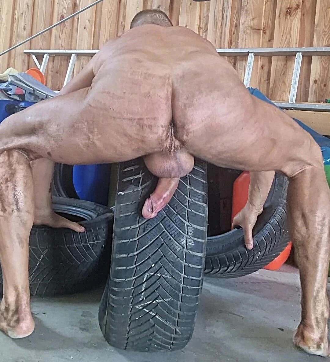 nude working in car tire shop