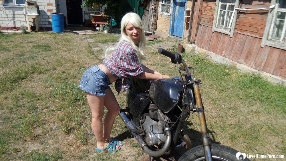 Blonde babe posing naked on a bike #5