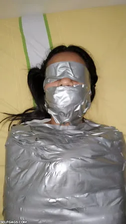 young girl duct tape wrapped like an egyptian mummy         