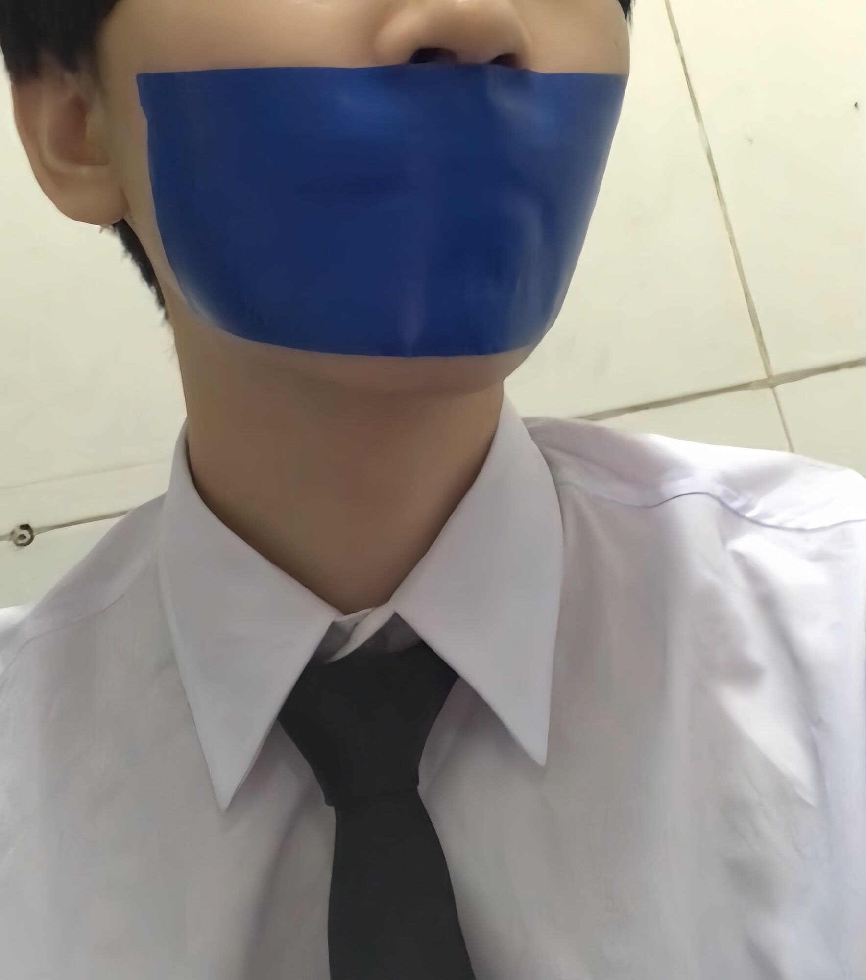 Wearing a white shirt and shiny black tie, gagged with duct  #18