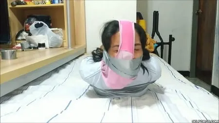 panty hooded girl gagged with socks and tape         