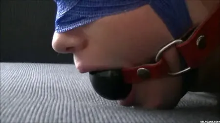 struggling bondage girl gagged with tape and ball         