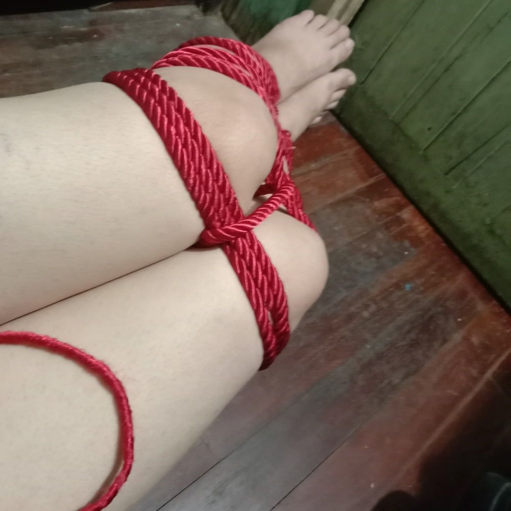 His white legs were tied with a red rope. #15