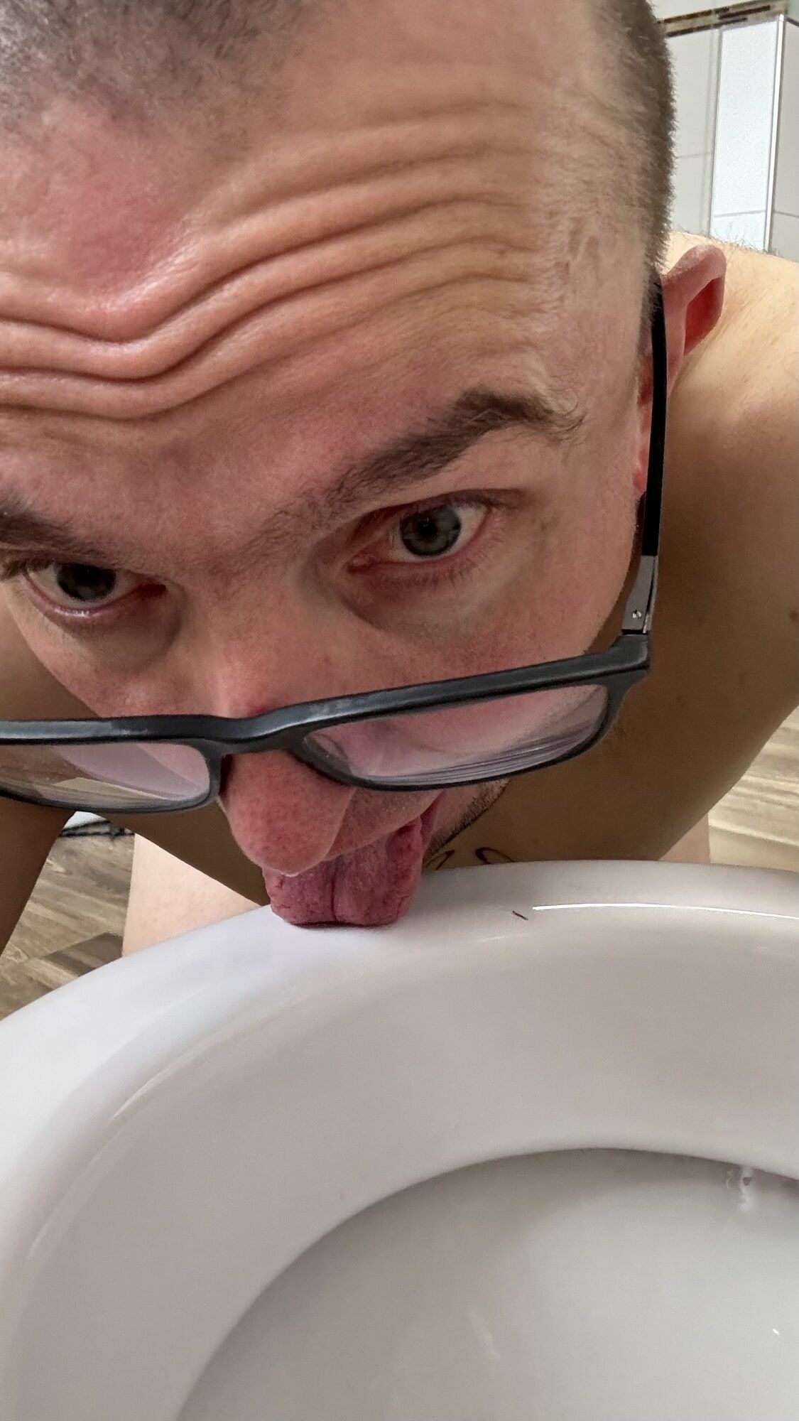Slave pig has to clean toilet with his tongue