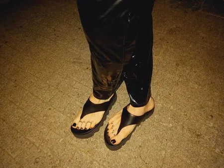 platform flip flops and latex pants         