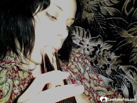 smoking wife using a long metal dildo         