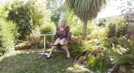 crossdress enjoying morning sun in garden         