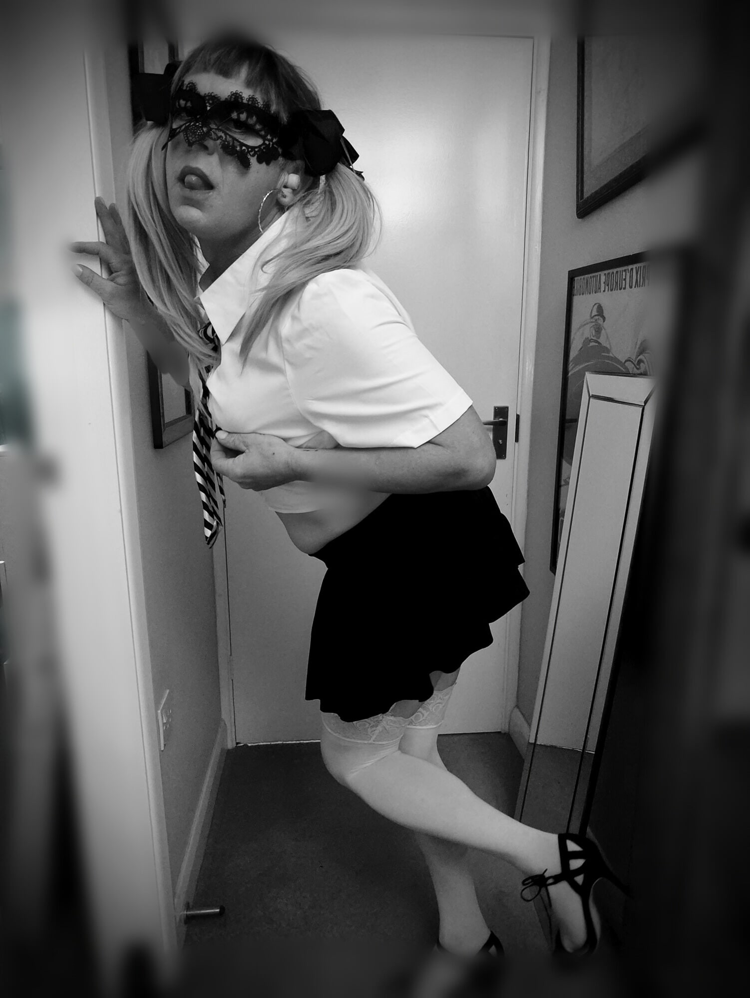 Sexy blonde schoolgirl with pigtails poses in white stocking