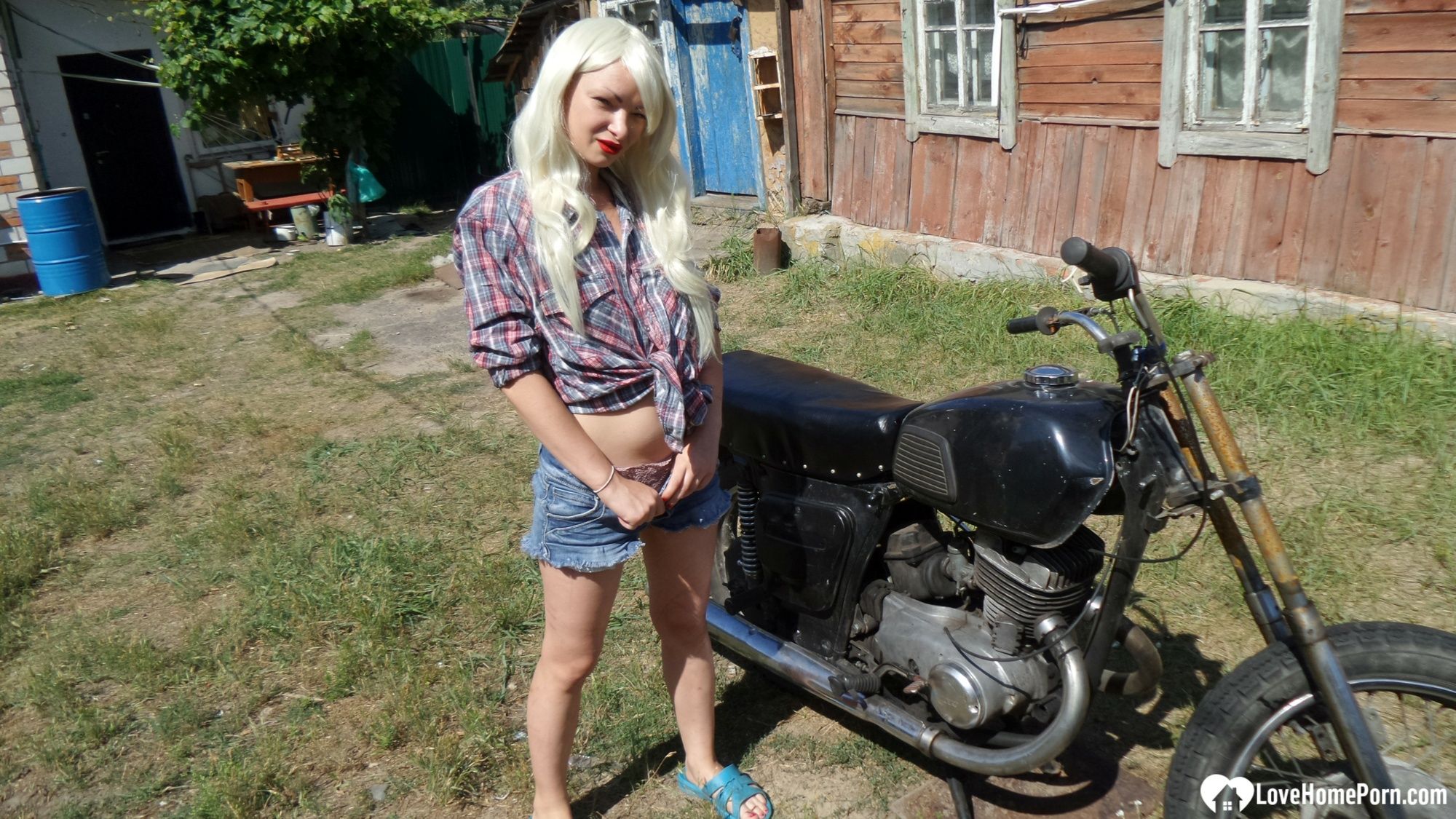 Blonde babe posing naked on a bike #6