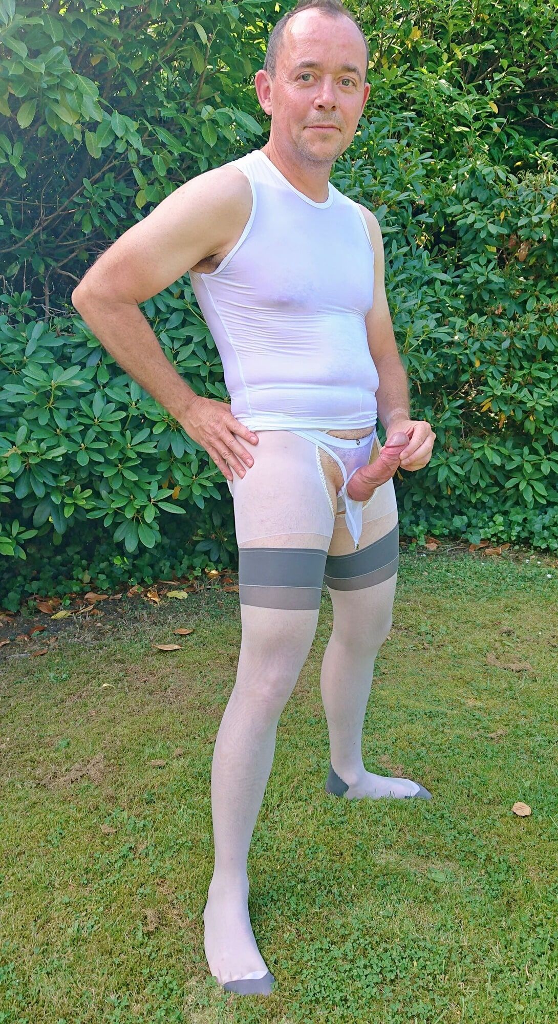 Posing in sexy nylon lingerie in a garden #16